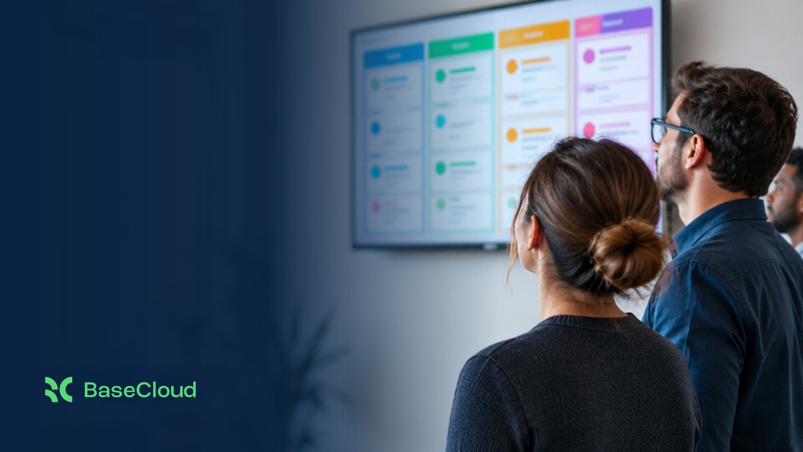 A team lead looking up at a wall display of a sales pipeline board in a bright office